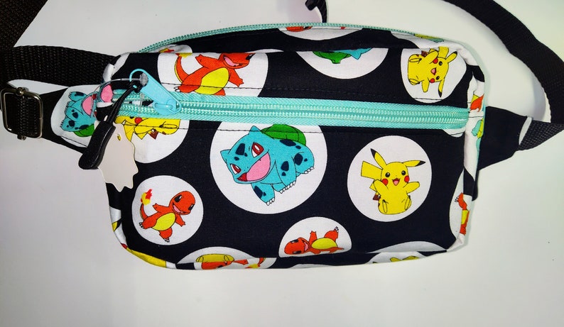Black character-print fanny pack with blue zipper