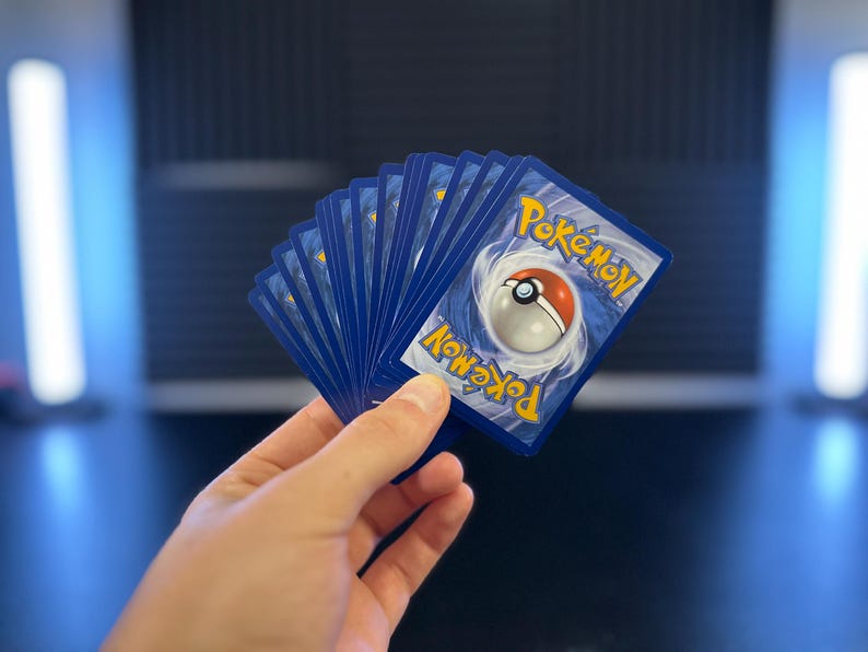 Authentic modern Pokémon cards included with the handmade LED Pokéball
