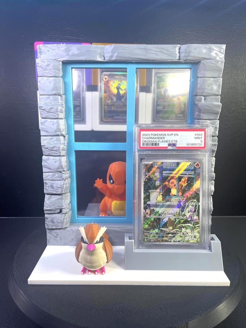 3D-printed Charmander and Pidgey window display stand for graded trading cards